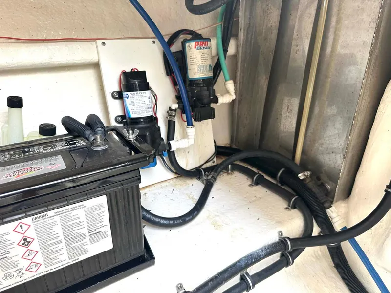 Slide: The Image of 1999 Wellcraft 45 Excalibur engine compartment with battery and wiring. - 43