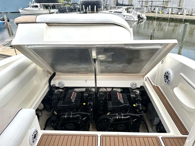 Slide: The Image of 1999 Wellcraft 45 Excalibur boat engine compartment with twin engines, docked at marina. - 45
