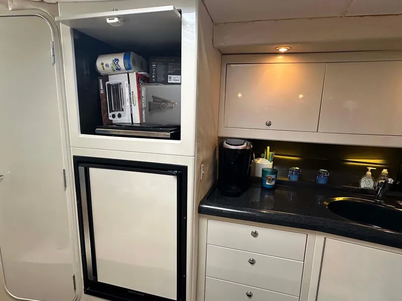 Slide: The Image of 1999 Wellcraft 45 Excalibur yacht interior kitchen with cabinets and appliances. - 6