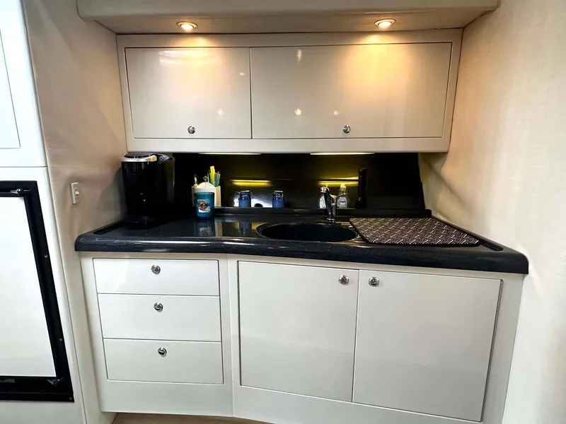 Slide: The Image of 1999 Wellcraft 45 Excalibur yacht kitchen with sleek cabinets and modern appliances. - 7