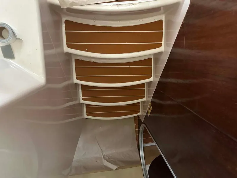 Slide: The Image of Interior view of 1998 Fountaine Pajot Athena 38 catamaran, featuring wooden steps and white trim. - 11