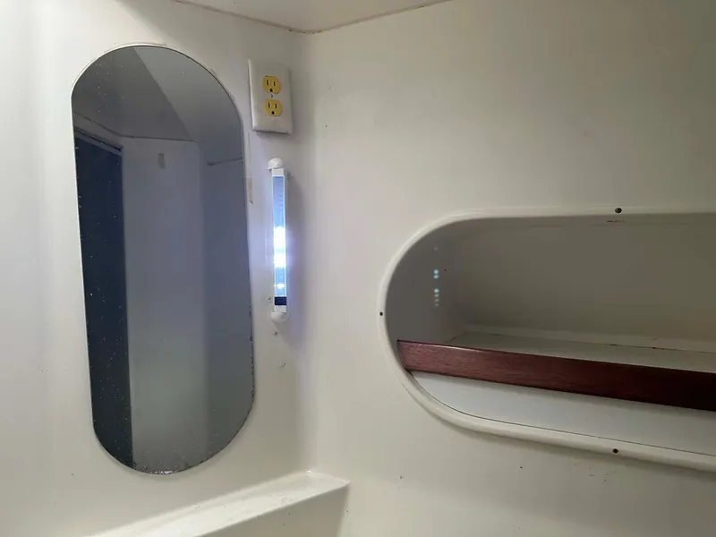 Slide: The Image of Interior of 1998 Fountaine Pajot Athena 38, featuring a mirror and storage shelf. - 16