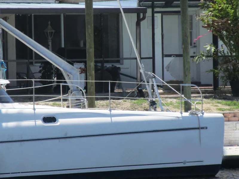 Slide: The Image of 1998 Fountaine Pajot Athena 38 catamaran docked near a house. - 22