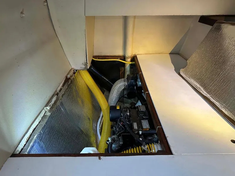 Slide: The Image of Engine compartment of 1998 Fountaine Pajot Athena 38 catamaran with yellow hoses and insulation. - 30