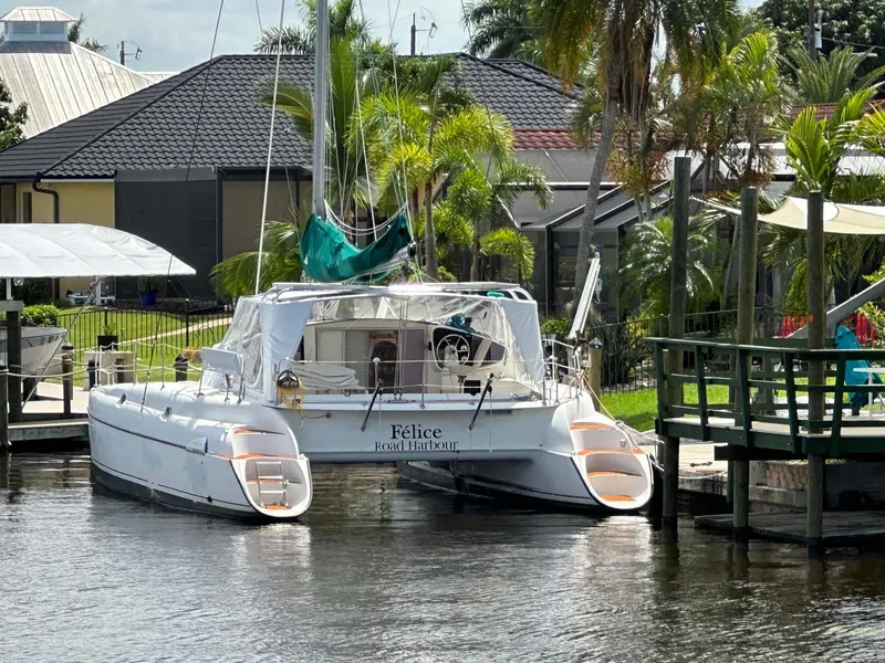 Slide: The Image of Fountaine Pajot Athena 38 catamaran docked by palm trees, 1998 model. - 40