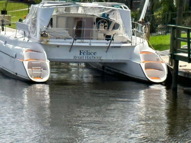 Slide: The Image of Fountaine Pajot Athena 38 catamaran docked on a calm waterway, 1998 model. - 41