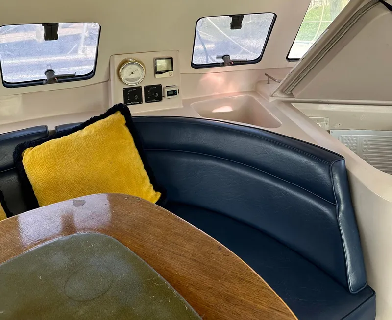 Slide: The Image of Interior of 1998 Fountaine Pajot Athena 38 with blue seating and yellow cushion. - 5