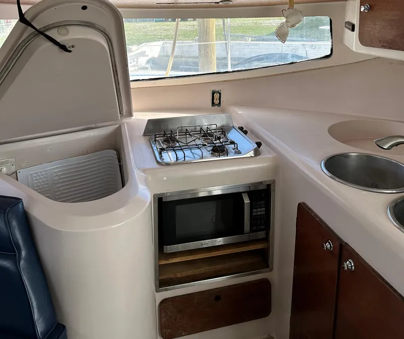 Slide: The Image of Interior of 1998 Fountaine Pajot Athena 38 yacht kitchen with stove and microwave. - 6