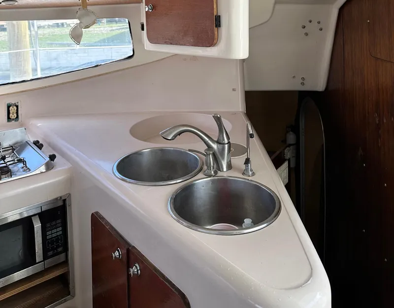Slide: The Image of Interior kitchen of 1998 Fountaine Pajot Athena 38 catamaran with dual sinks and microwave. - 9