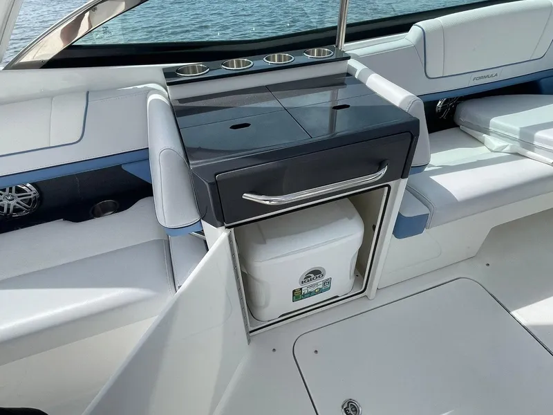 Slide: The Image of 2023 Formula 330 Crossover Bowrider OB interior with built-in cooler and seating. - 30