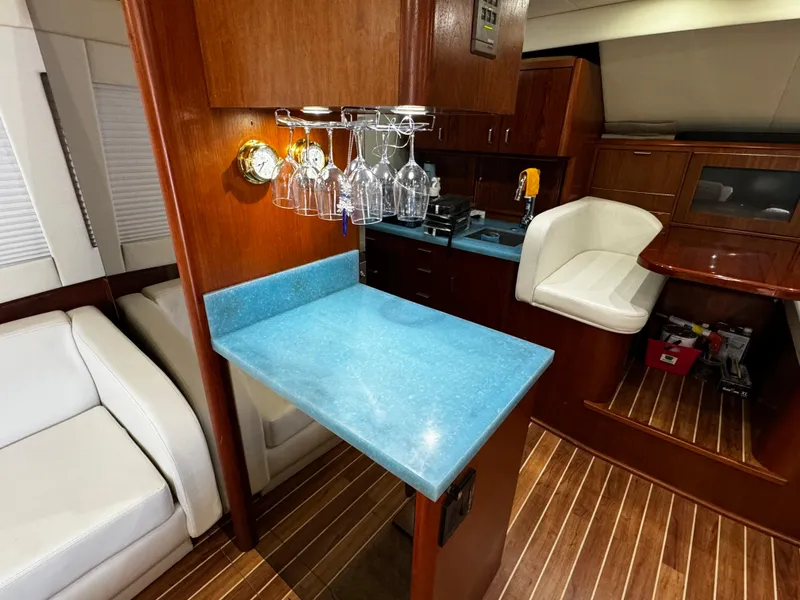 Slide: The Image of Luxurious 1992 Ocean Yachts 48 Convertible interior with blue countertop and wooden accents. - 17