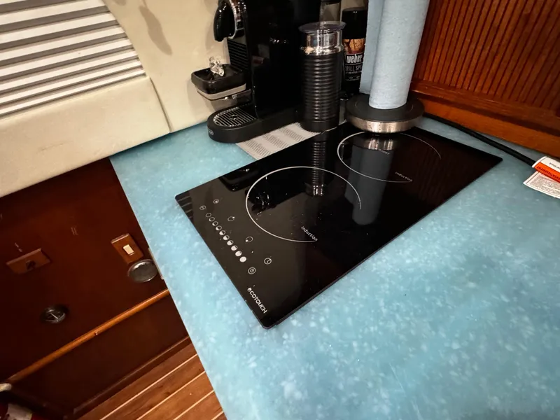 Slide: The Image of Induction cooktop on Ocean Yachts 48 Convertible, 1992 model, with blue countertop. - 22