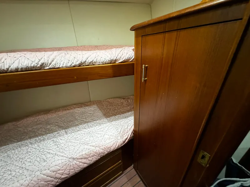 Slide: The Image of 1992 Ocean Yachts 48 Convertible cabin with wooden bunk beds and closet. - 28
