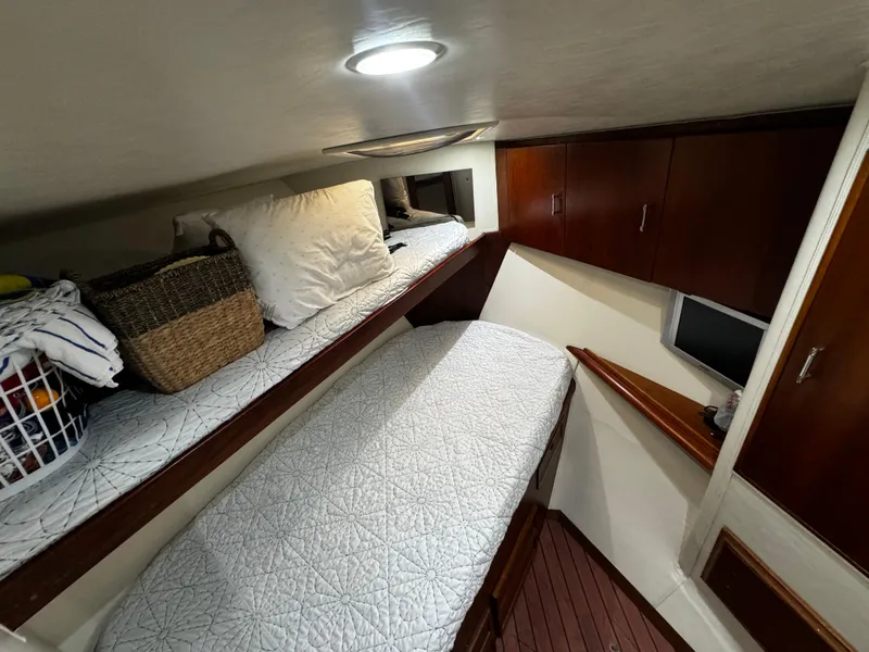 Slide: The Image of Cozy cabin interior of 1992 Ocean Yachts 48 Convertible with twin beds and storage. - 30