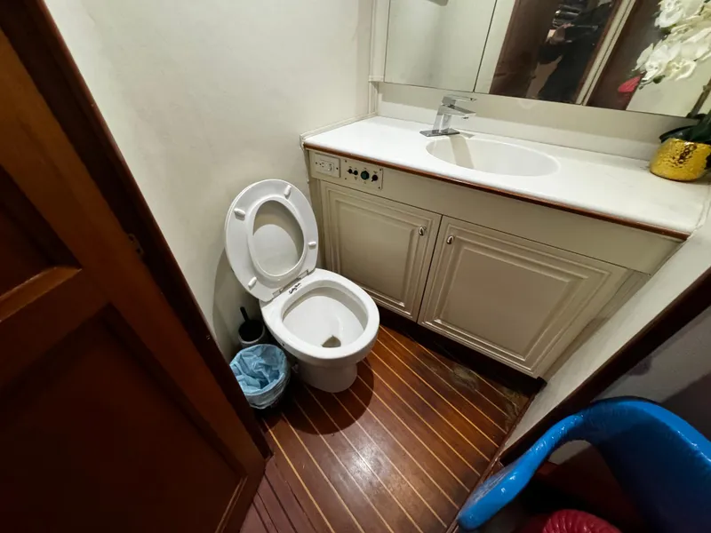 Slide: The Image of Bathroom interior of 1992 Ocean Yachts 48 Convertible with wooden flooring and white fixtures. - 36