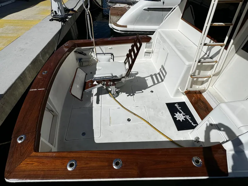 Slide: The Image of 1992 Ocean Yachts 48 Convertible fishing deck with chair and wooden trim. - 38