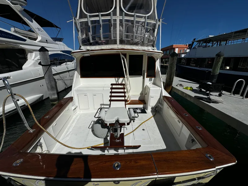 Slide: The Image of 1992 Ocean Yachts 48 Convertible docked, featuring spacious deck and fishing chair. - 40