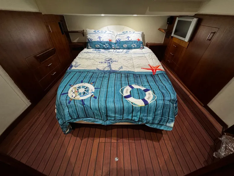 Slide: The Image of Cozy bedroom in 1992 Ocean Yachts 48 Convertible with nautical-themed bedding. - 5