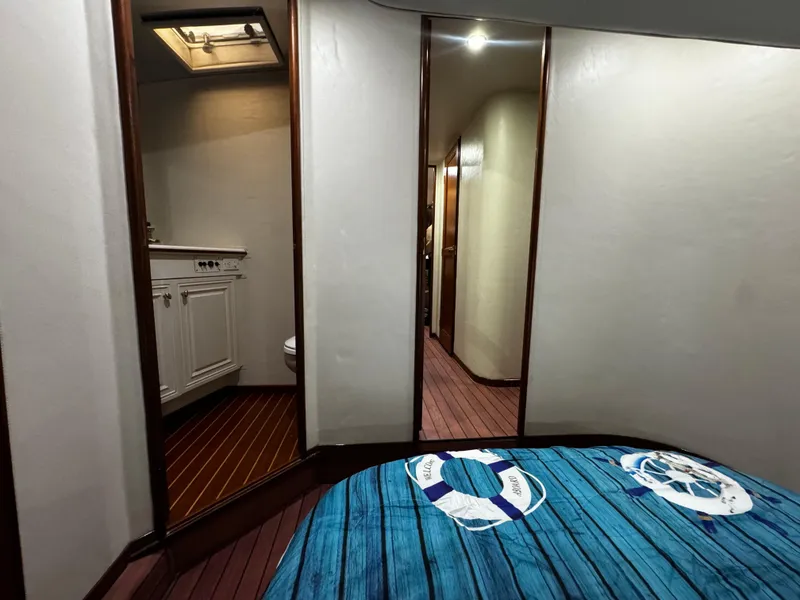 Slide: The Image of Interior of 1992 Ocean Yachts 48 Convertible, featuring a cozy bedroom and bathroom. - 6