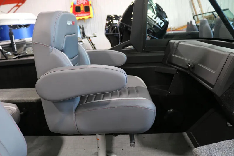 Slide: The Image of 2025 Alumacraft Competitor 175X Sport boat interior with gray seating and dashboard. - 12