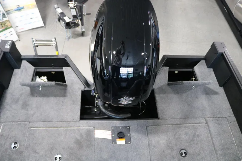Slide: The Image of 2025 Alumacraft Competitor 175X Sport boat interior with motor and storage compartments. - 20