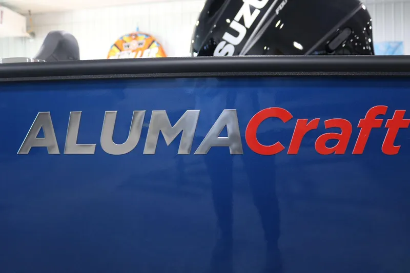 Slide: The Image of Close-up of 2025 Alumacraft Competitor 175X Sport boat logo on blue surface. - 21