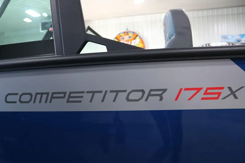 Slide: The Image of 2025 Alumacraft Competitor 175X Sport boat side view with logo detail. - 22