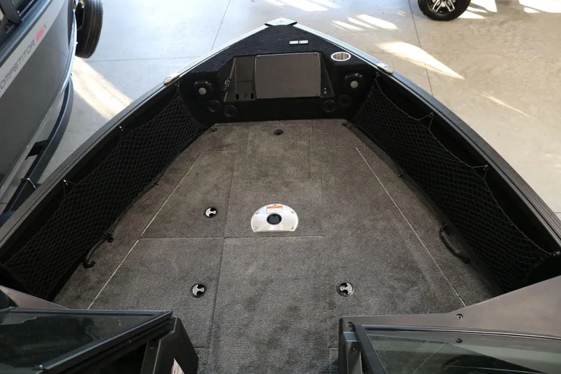 Slide: The Image of 2025 Alumacraft Competitor 175X Sport boat interior with spacious deck and storage nets. - 7