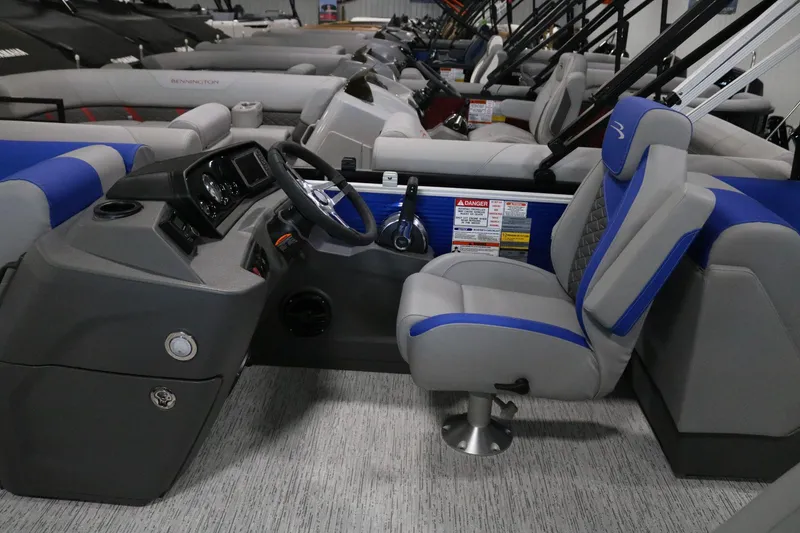 Slide: The Image of 2025 Bennington 22 S STERN RADIUS boat interior with steering console and seating. - 11