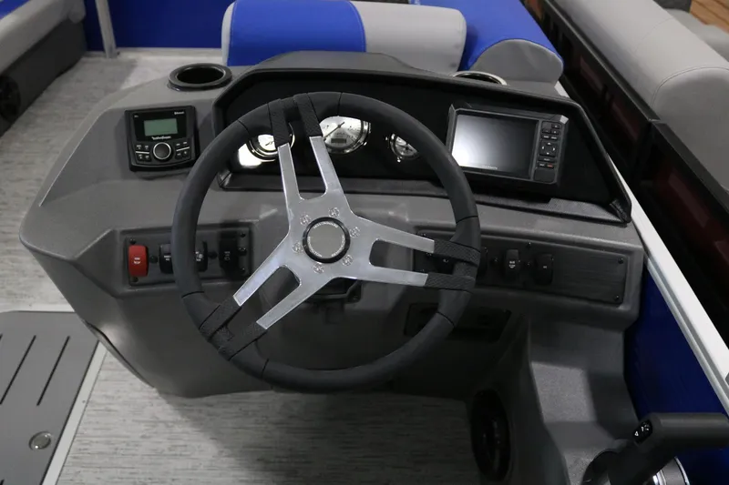 Slide: The Image of 2025 Bennington 22 S STERN RADIUS boat dashboard with steering wheel and controls. - 12
