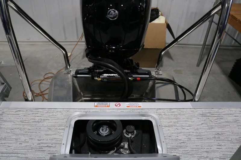Slide: The Image of 2025 Bennington 22 S STERN RADIUS boat engine and stern view in a garage. - 20