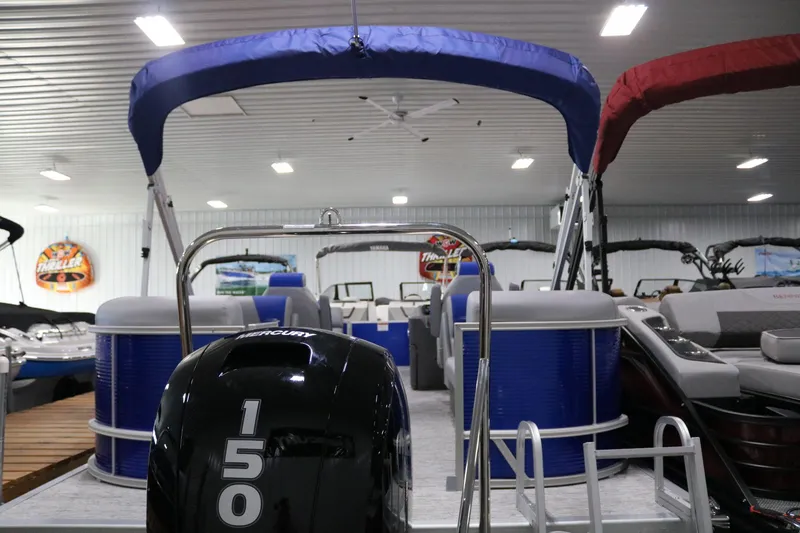 Slide: The Image of 2025 Bennington 22 S STERN RADIUS pontoon boat with Mercury 150 engine in showroom. - 22
