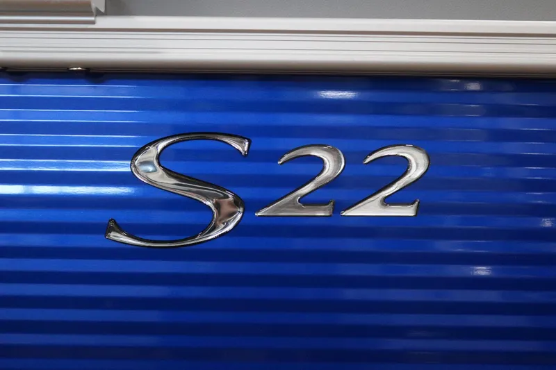 Slide: The Image of Blue Bennington 2025 S22 Stern Radius boat with metallic lettering. - 23