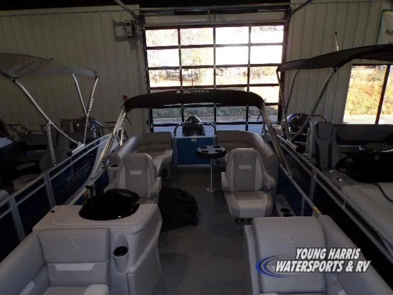 Slide: The Image of 2025 Godfrey EX2286SB pontoon boat interior in showroom setting. - 3