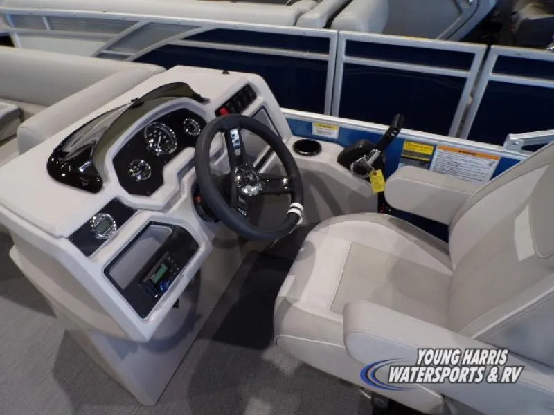 Slide: The Image of 2025 Godfrey EX2286SB boat helm with steering wheel and controls. - 6