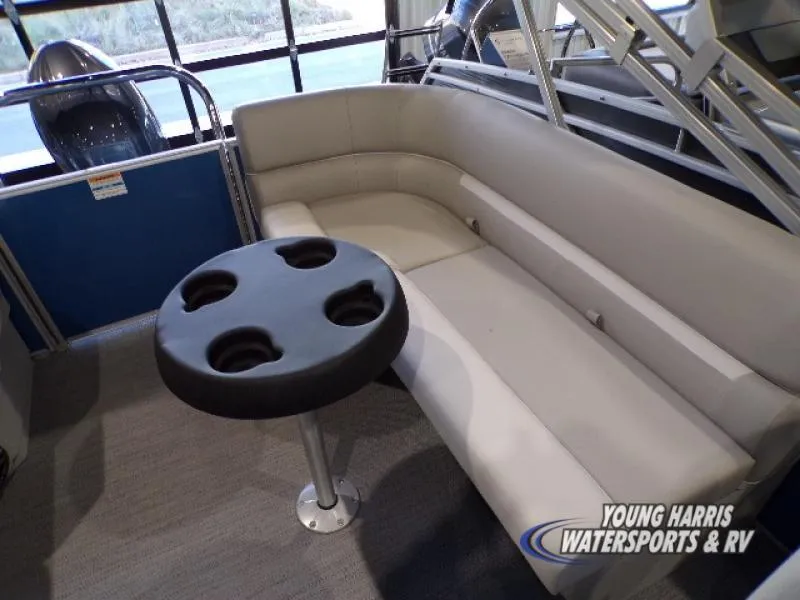 Slide: The Image of Luxurious seating area on 2025 Godfrey EX2286SB pontoon boat with cup holder table. - 8