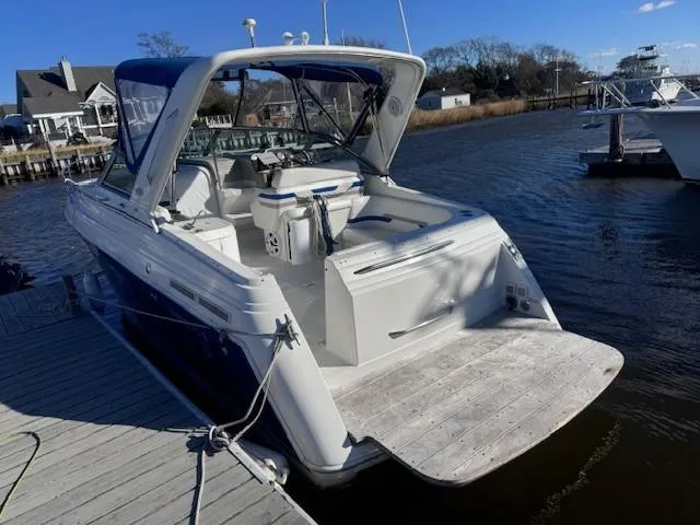 Slide: The Image of 2003 Formula 27 PC boat docked, featuring spacious deck and blue canopy. - 1