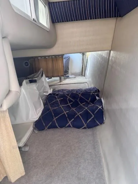 Slide: The Image of Interior cabin of 2003 Formula 27 PC boat with blue bedding and storage. - 11