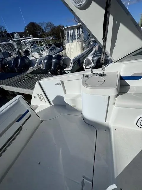 Slide: The Image of 2003 Formula 27 PC boat interior with docked vessels in the background. - 15