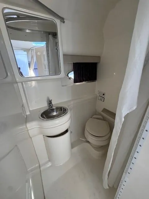 Slide: The Image of 2003 Formula 27 PC boat bathroom with sink, toilet, and mirror. - 22
