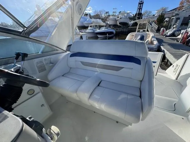 Slide: The Image of 2003 Formula 27 PC boat interior with white seating and steering wheel. - 23