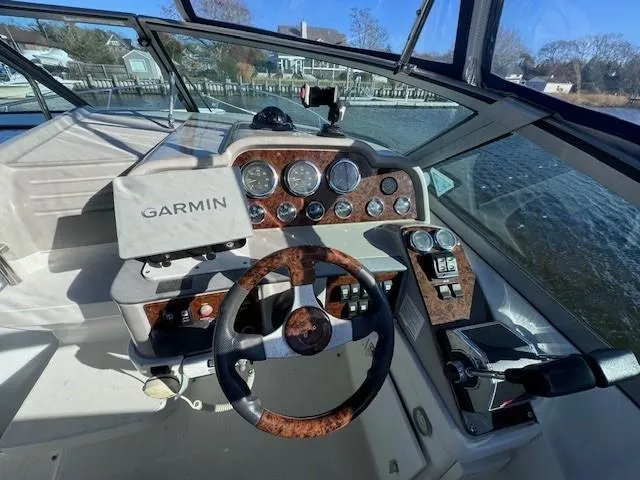 Slide: The Image of 2003 Formula 27 PC boat cockpit with Garmin navigation system and wood-accented steering wheel. - 26