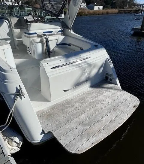 Slide: The Image of 2003 Formula 27 PC boat with spacious deck, docked by the water. - 29