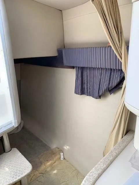 Slide: The Image of 2003 Formula 27 PC cabin interior with striped curtains and beige walls. - 3