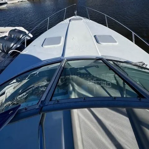 Slide: The Image of 2003 Formula 27 PC boat deck with windshield, docked on calm water. - 30