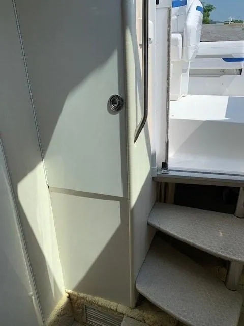 Slide: The Image of 2003 Formula 27 PC boat interior with stairs and seating area. - 5