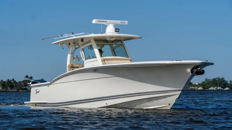 Slide: The Image of 2012 Scout 345 XSF boat cruising on a sunny day. - 1