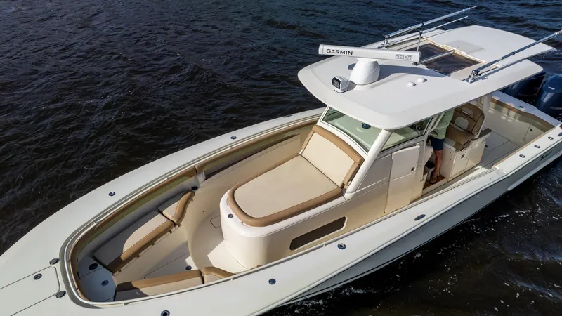 Slide: The Image of 2012 Scout 345 XSF boat on water, featuring sleek design and spacious deck. - 11