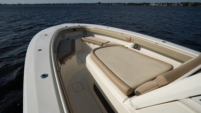 Slide: The Image of 2012 Scout 345 XSF boat with spacious deck and seating on open water. - 12