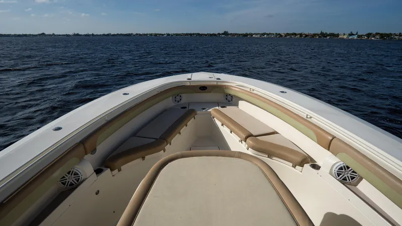 Slide: The Image of 2012 Scout 345 XSF boat on open water, featuring spacious seating and sleek design. - 13